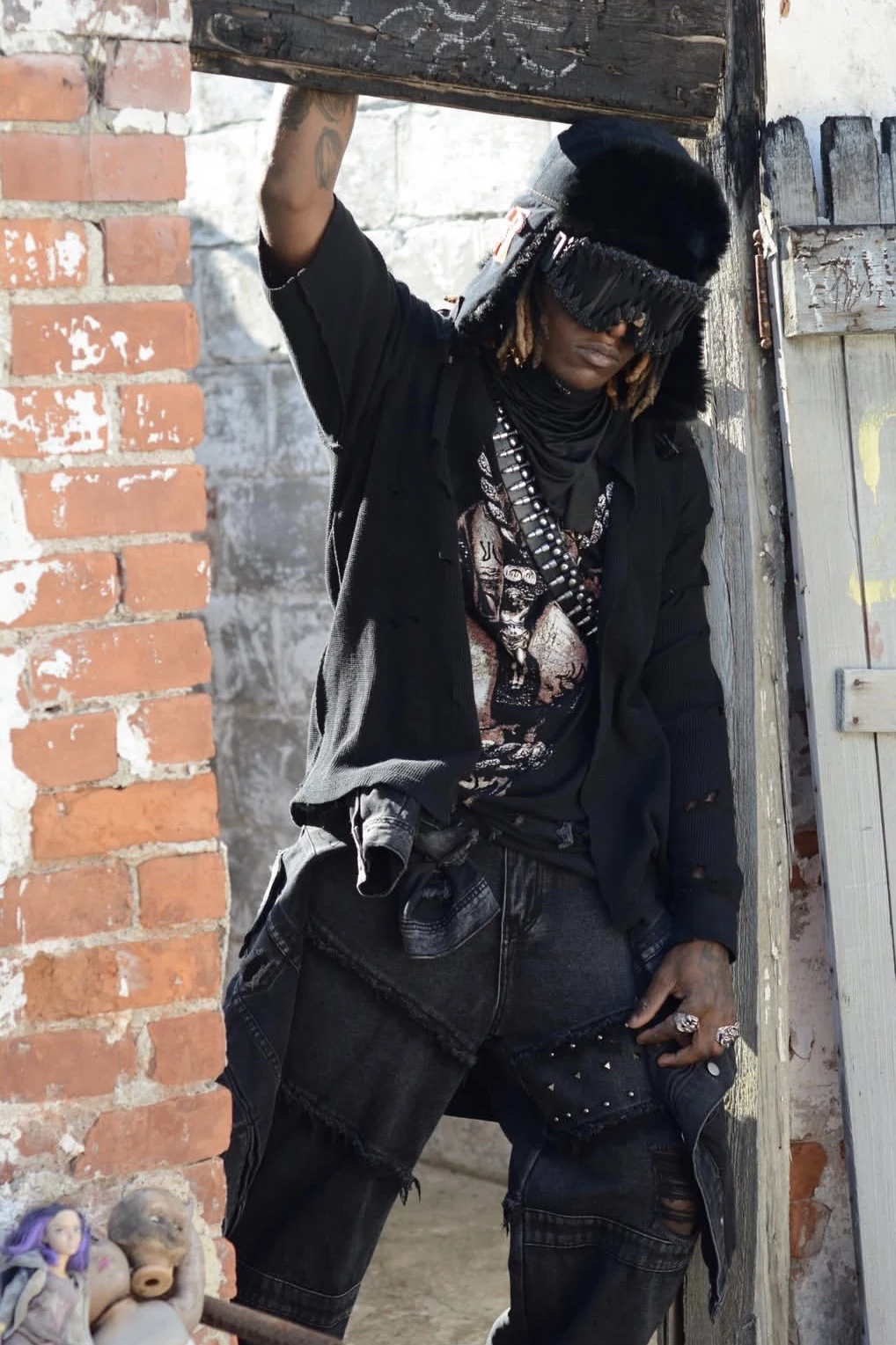 Kameron in layered black streetwear.