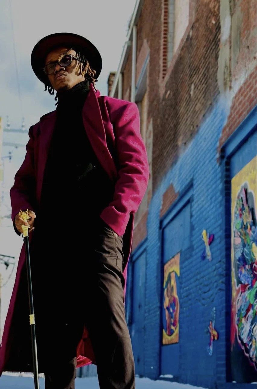 Kameron in a magenta coat.